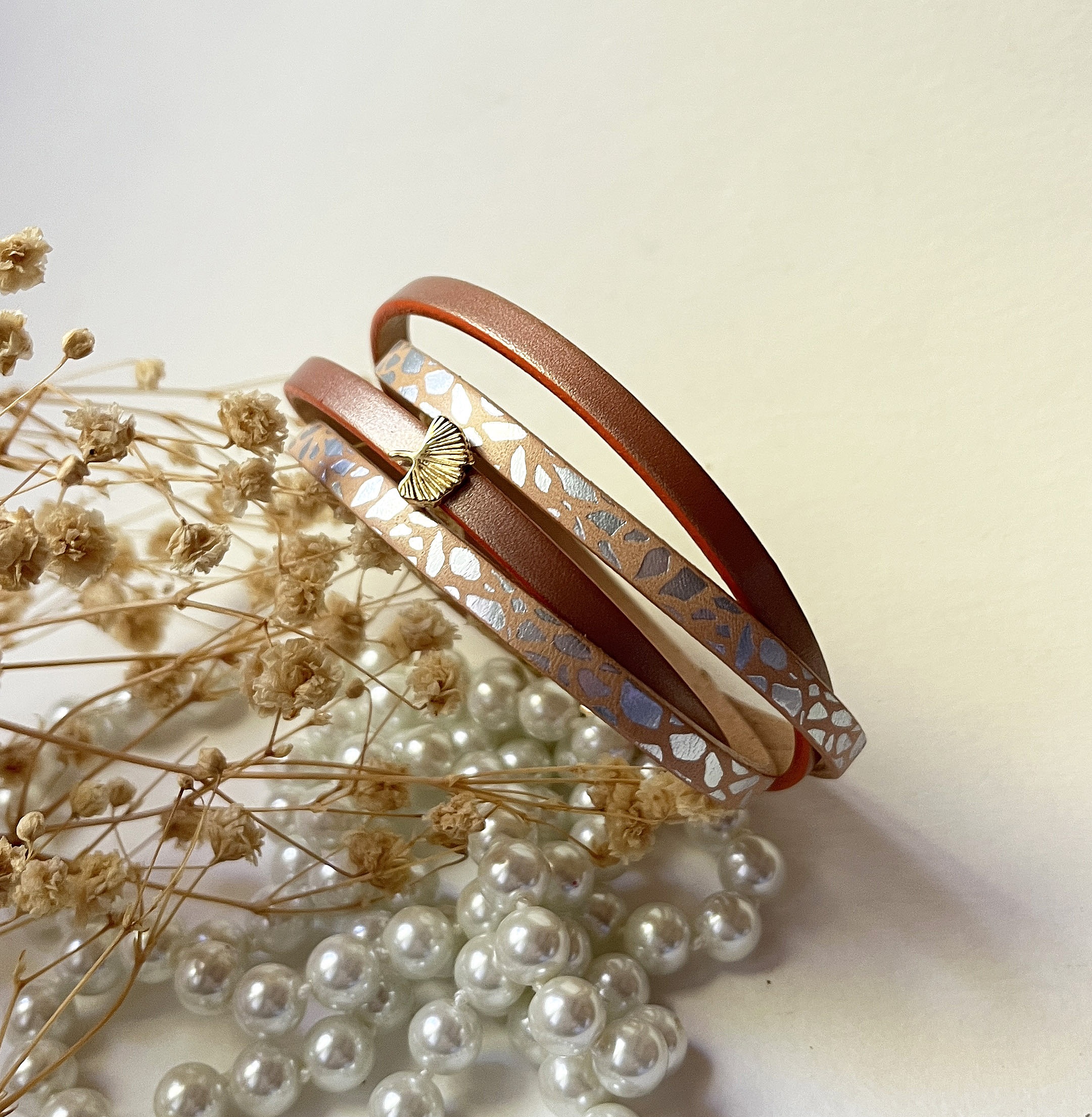 Bracelet zen en cuir bicolore avec pendentif ginkgo doré.